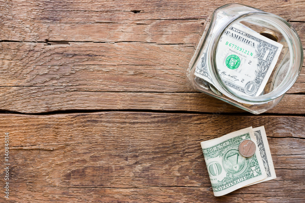 jar for fundraising and money on a wooden background jar for fundraising and money on a wooden background