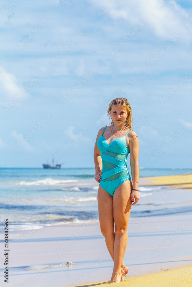 Girl model standing on the tropical beach Girl model standing on the tropical beach