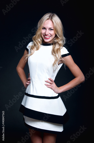 Blonde woman wearing white dress photo