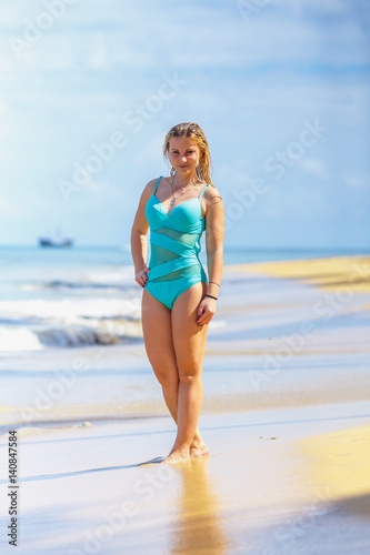 Girl model standing on the tropical beach