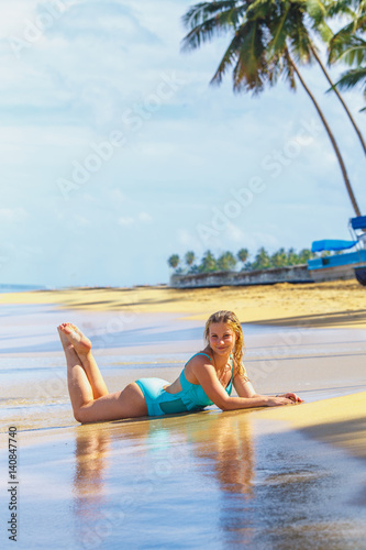 Girl lying on stomach on beach