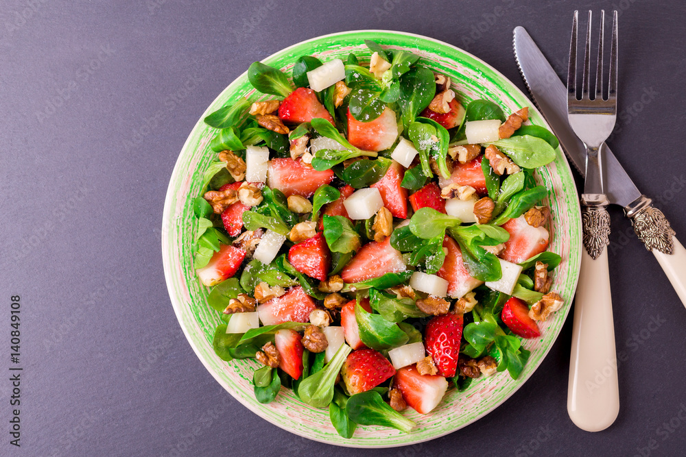 Salad with strawberry, spinach, walnuts and goat cheese
