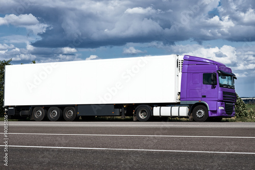 Truck on road with white blank container, blue sky, cargo transportation concept