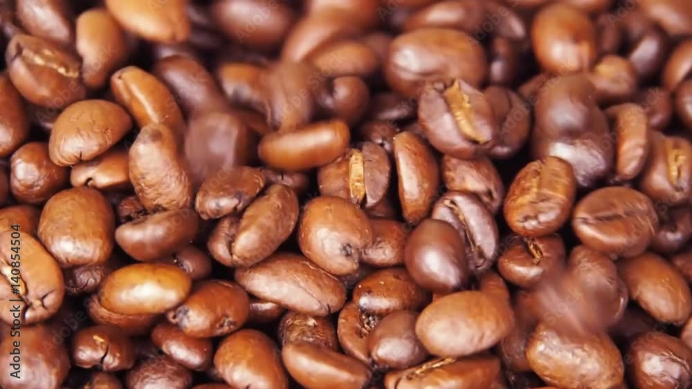 Coffee beans are strewed close up. Grains are poured. Slow motion. Coffee beans are strewed close up. Grains are poured. Slow motion.