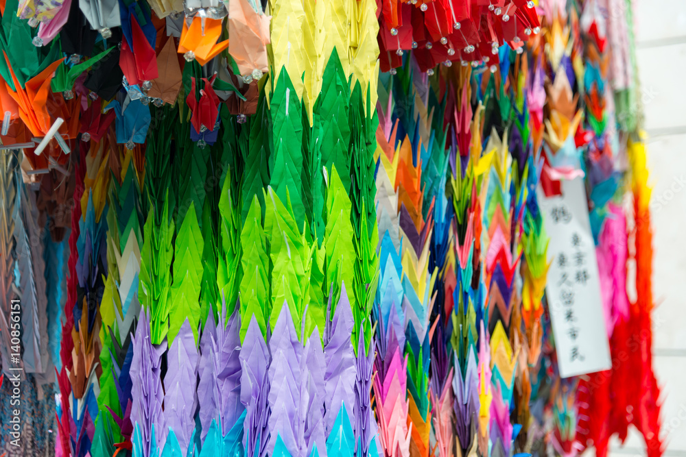 Thousand colorful origami paper cranes with a shallow depth of field