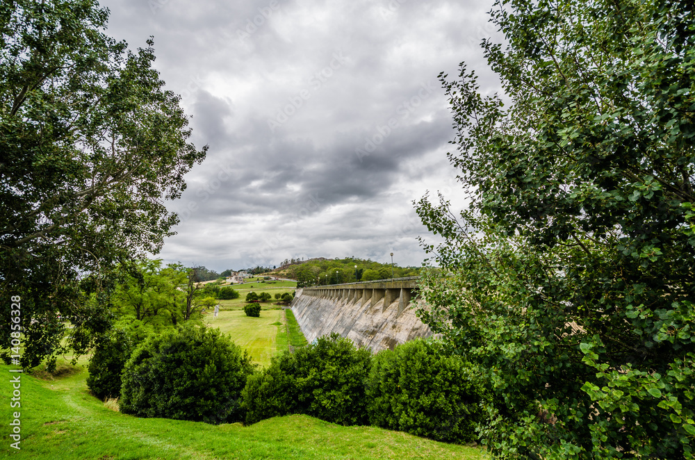 Old dam amongst green forest trees on a cloudy day Old dam amongst green forest trees on a cloudy day