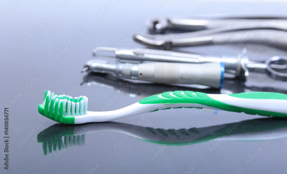 dental care toothbrush with dentist tools on mirror background. dental care toothbrush with dentist tools on mirror background.