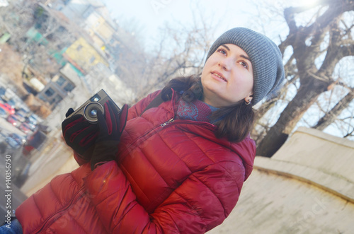 A beautiful young woman with a camera photo