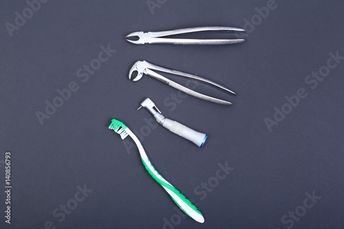 dental care toothbrush with dentist tools on mirror background.