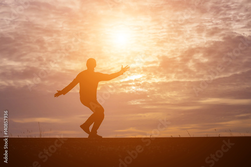 Man show hands silhouette sunset background