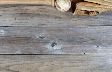 Top border of used baseball equipment on rustic wooden boards