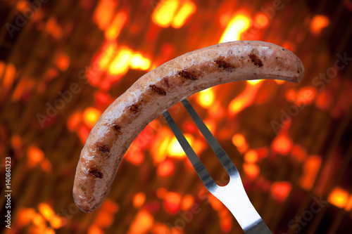 Sausage on Fork over BBQ Flame