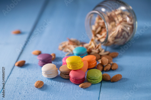 Colorful macarons on blue table background