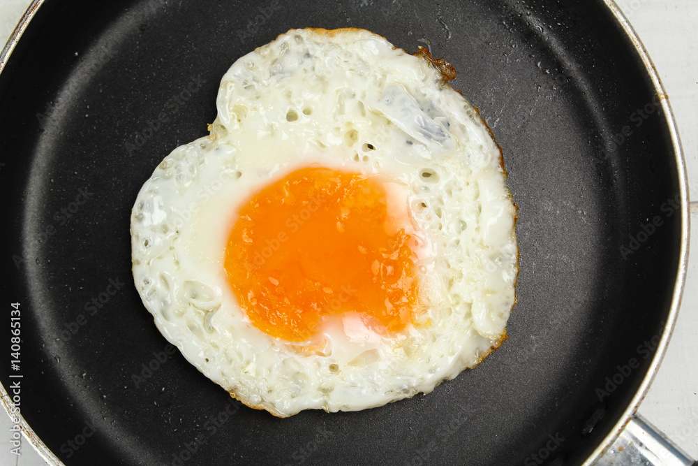 fried egg heart-shaped for breakfast on plate fried egg heart-shaped for breakfast on plate