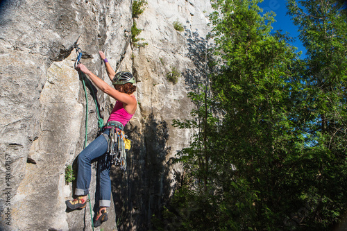 Woman rock climbing on Ontario's Niagara Escarpment in Canada