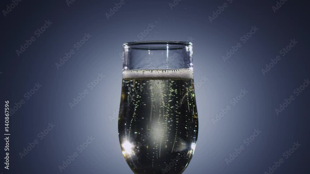 Slow motion. Bubbles of champagne wine disappear from the drink Slow motion. Bubbles of champagne wine disappear from the drink