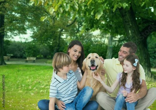 Happy family with pet dog enjoying in park