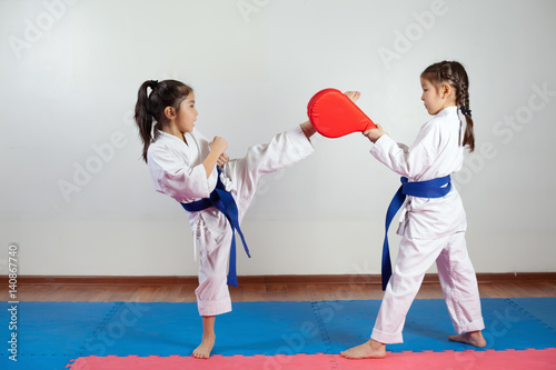 Two little girls demonstrate martial arts working together