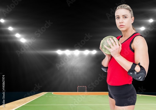 Female handball player holding ball at handball court