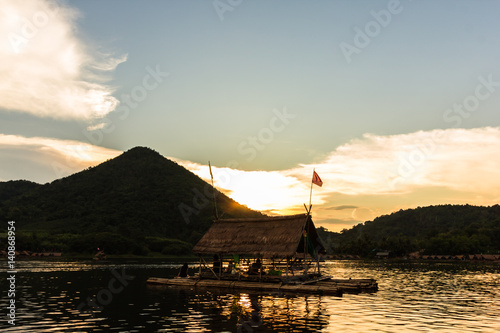 a bamboo raft on river on sunset