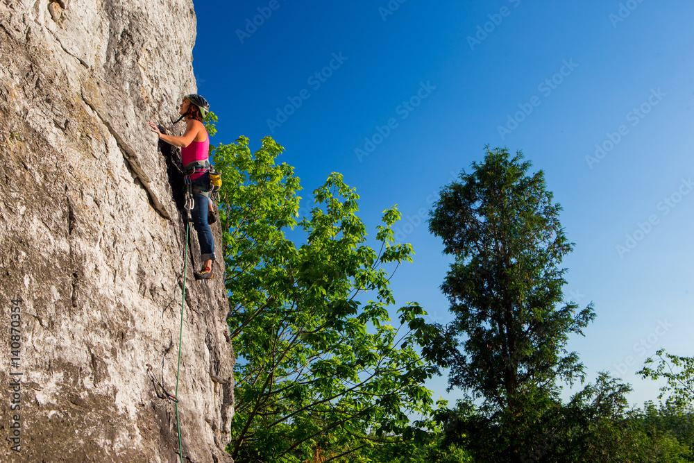 Woman rock climbing on Ontario's Niagara Escarpment in Canada Woman rock climbing on Ontario's Niagara Escarpment in Canada
