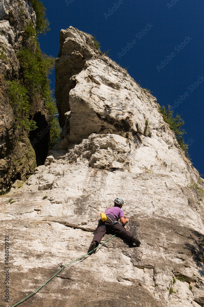 Man rock climbing on Ontario's Niagara Escarpment in Canada