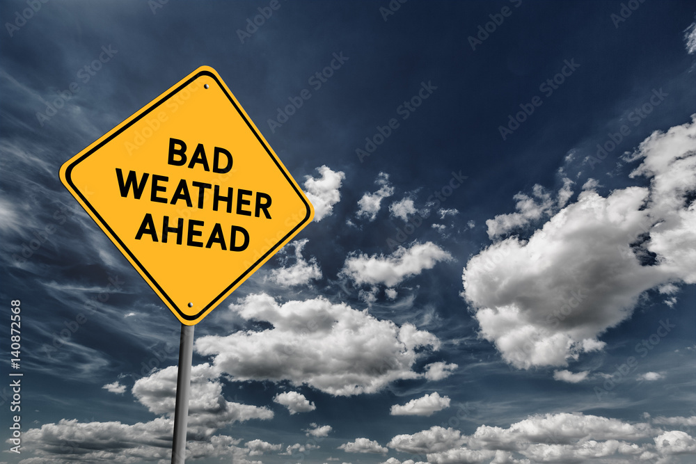 Dark blue cloudy sky and yellow road sign Dark blue cloudy sky and yellow road sign