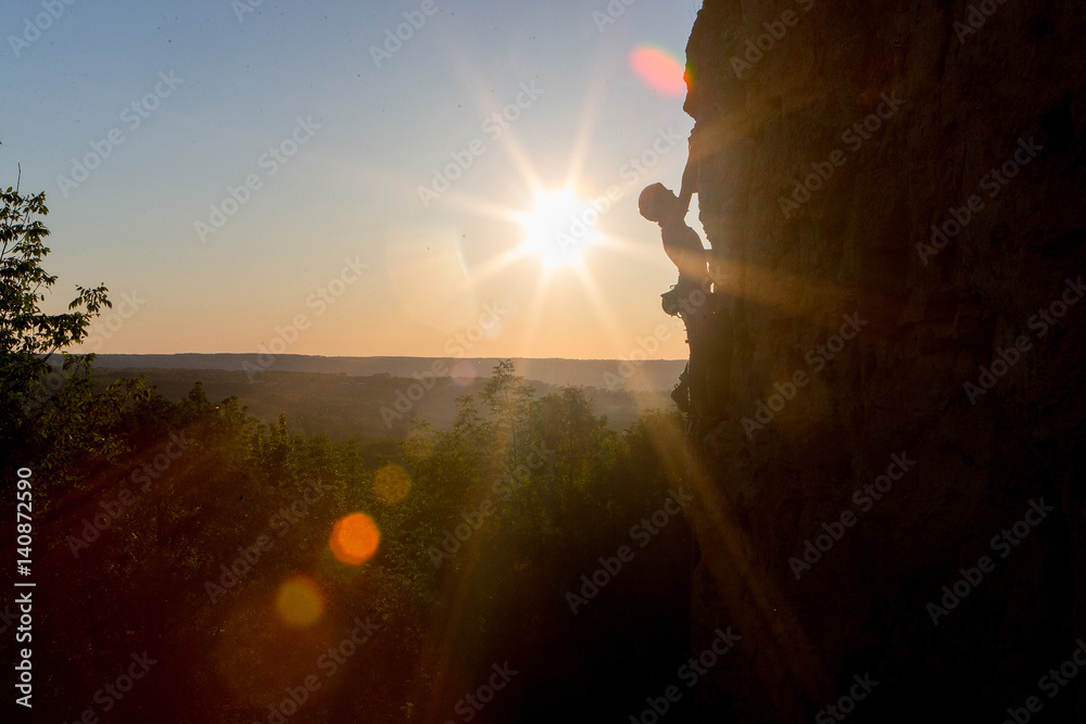 Silhouette of a Woman rock climbing on Ontario's Niagara Escarpment in Canada
