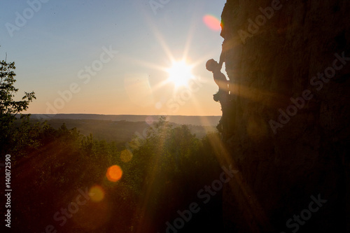 Obraz na płótnie Silhouette of a Woman rock climbing on Ontario's Niagara Escarpment in Canada w salonie