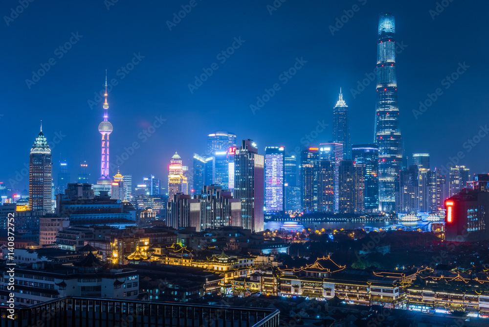 illuminated cityscape at night in financial district of China.
