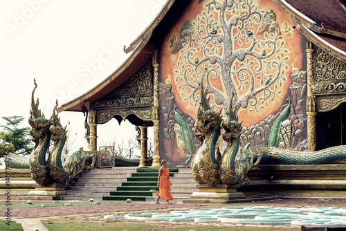Buddhist novice looking at beautiful chapel.  © KissShot