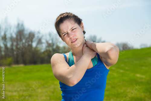 Young woman pain with neck injury at exercise .