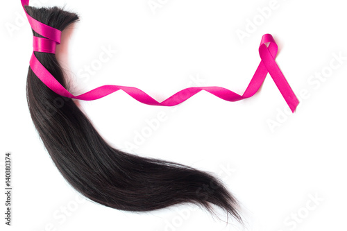 Hair with pink satin ribbon isolated on white background photo