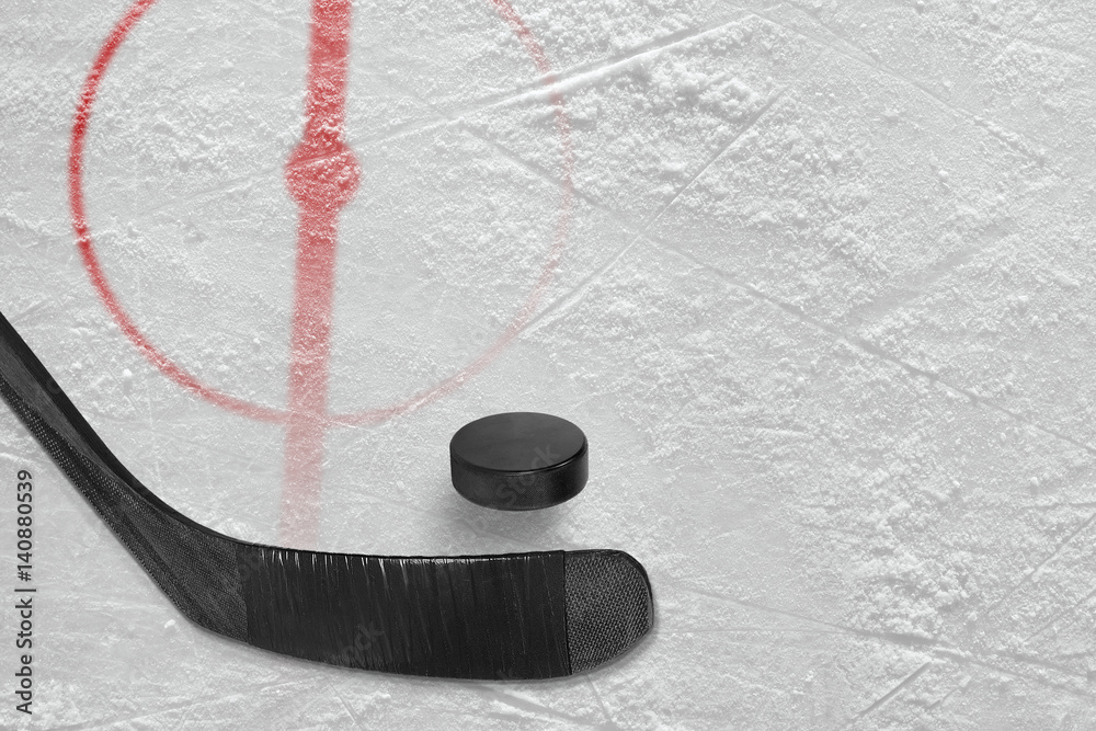 Fototapeta premium Fragment of ice hockey rink with a stick and puck