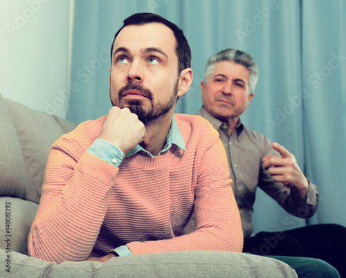 Fotografie Adult father and son solve problems