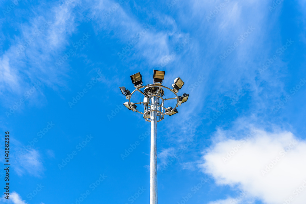 spotlight pole against blue sky