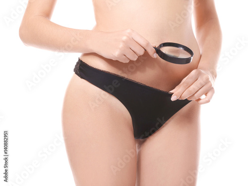 Close up view of young woman with magnifier on white background. Gynecology concept