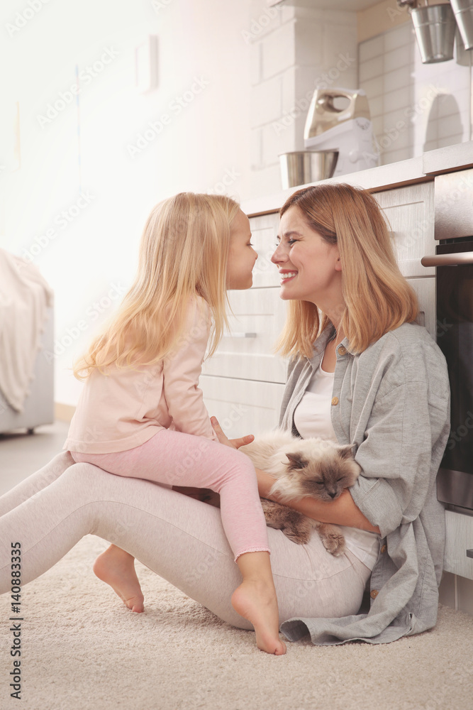 Mother and her daughter with cat at home Mother and her daughter with cat at home