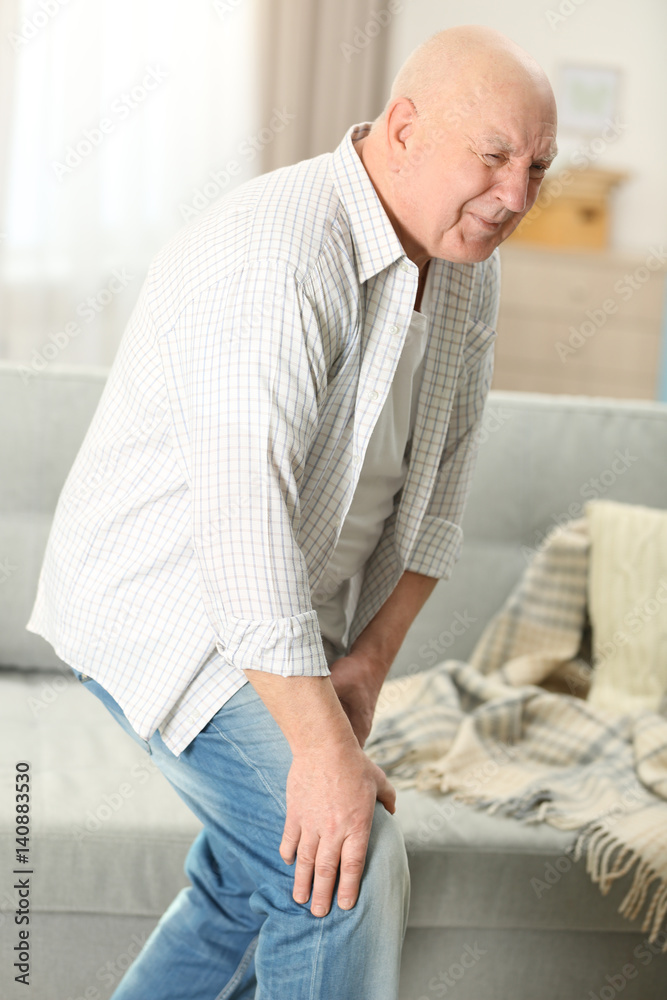 Mature man suffering from pain at home Mature man suffering from pain at home