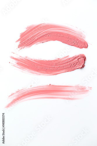 Texture of gently pink lipstick isolated on white background