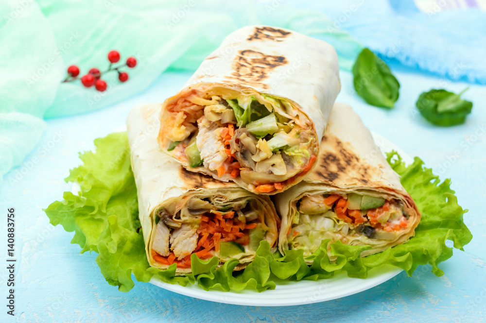 Shawarma - Middle Eastern dish made from lavash (pita), stuffed with chicken, mushrooms, fresh vegetable salad, sauce. Serving on lettuce leaves on a light background. The top view. Shawarma - Middle Eastern dish made from lavash (pita), stuffed with chicken, mushrooms, fresh vegetable salad, sauce. Serving on lettuce leaves on a light background. The top view.