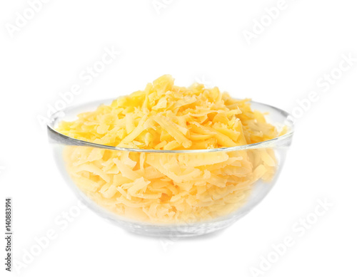 Glass bowl with grated cheese on white background