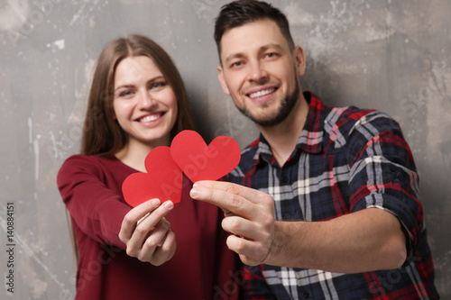 Happy young couple with red...
