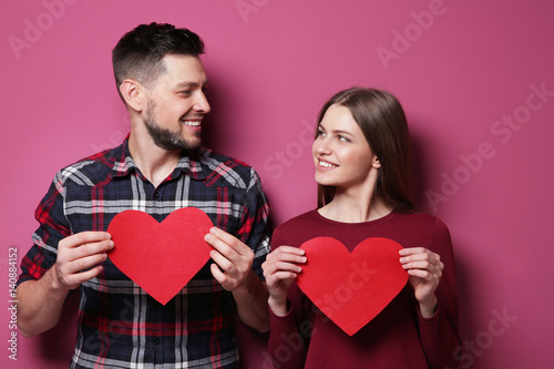 Happy young couple with red...