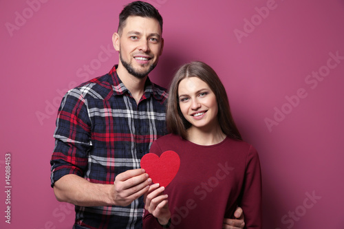 Happy young couple with red...