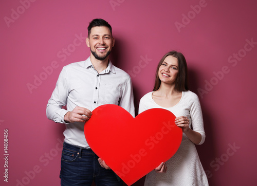 Happy young couple with red...