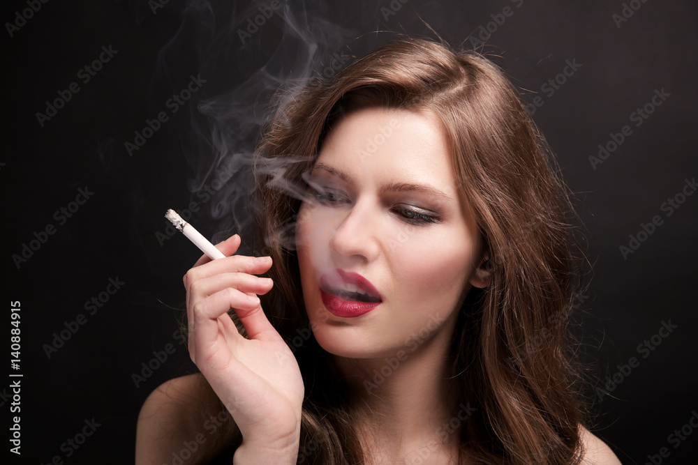 Portrait of beautiful woman with cigarette on black background Portrait of beautiful woman with cigarette on black background