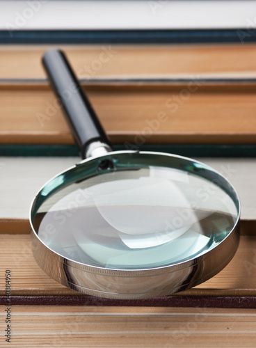 books and magnifying glass