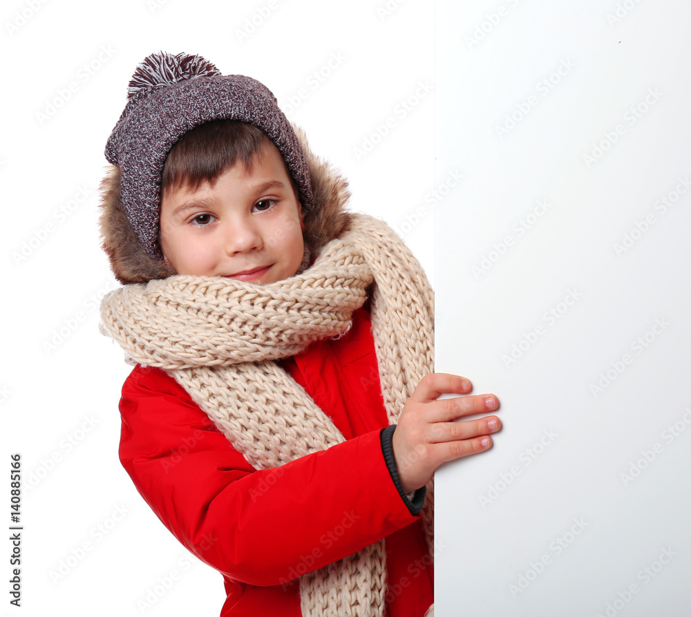 Obraz premium Cute little boy in warm clothes with poster on white background