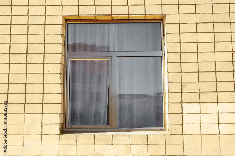 Fototapeta premium Modern plastic window on brick wall background